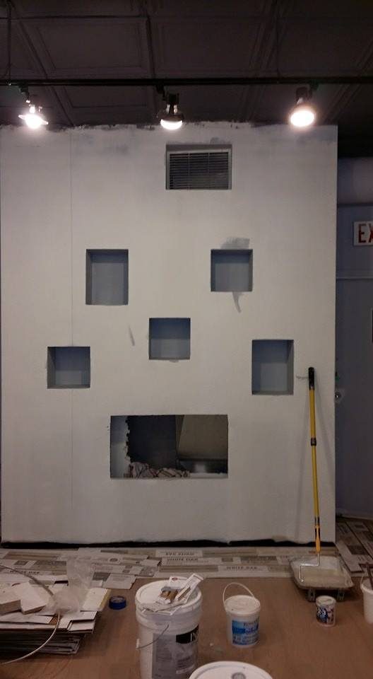 The feature wall before painting: bare, primed, with open display niches.