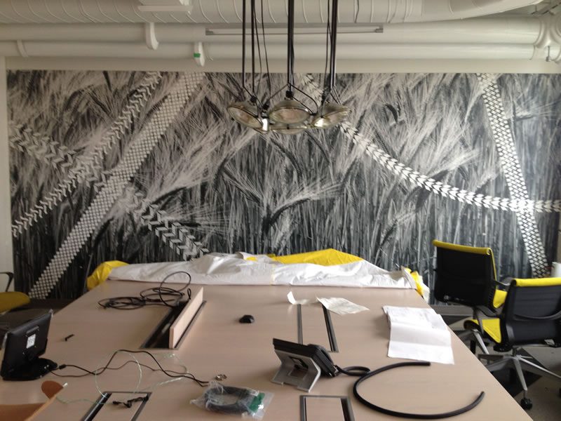 Line-drawing wall graphics across a commercial interior.