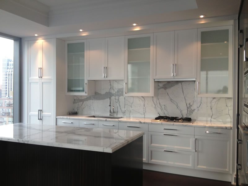 A white kitchen with painted cabinetry and trim.