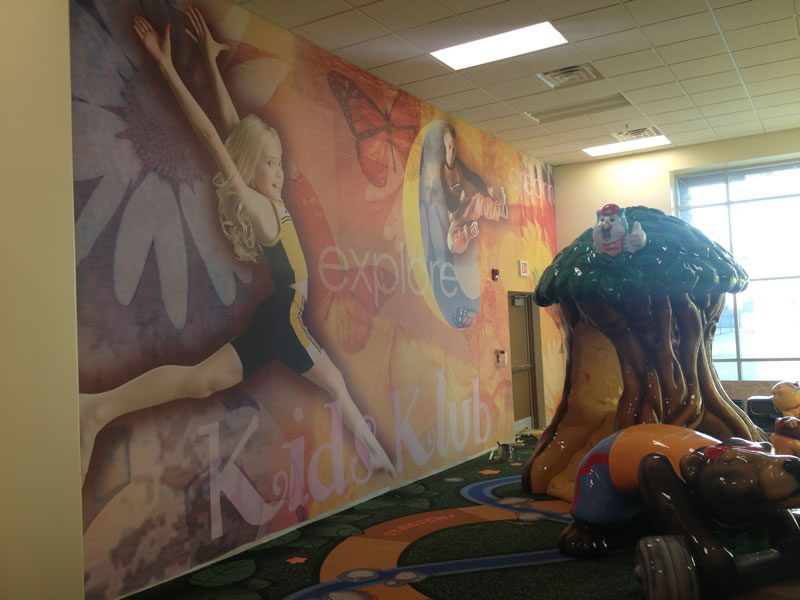 A children's play-space mural with a painted mushroom and flowers.