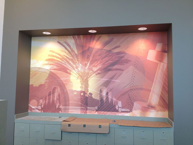 A painted palm tree mural across a feature wall.