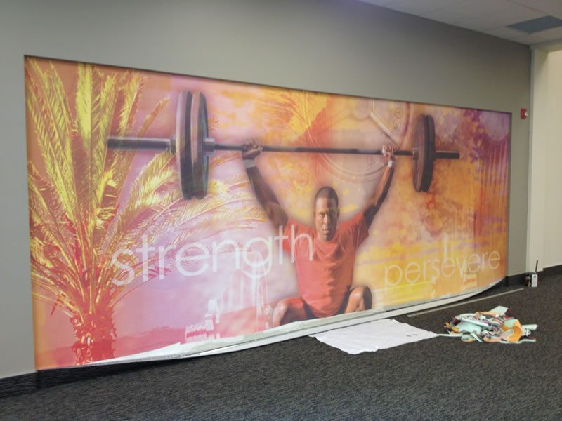 A large-scale mural filling a commercial fitness studio wall.